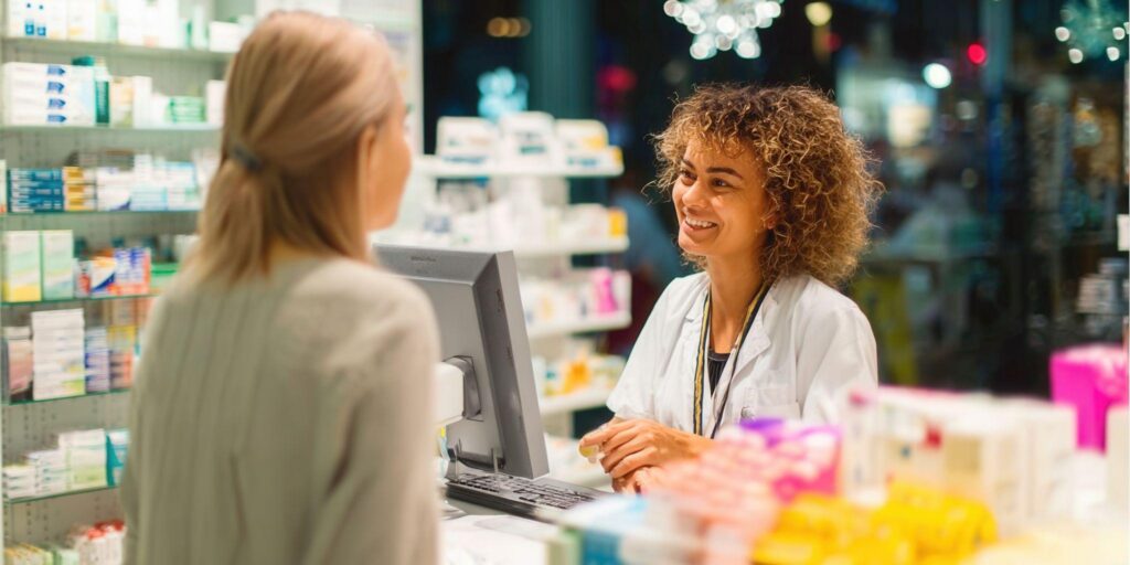 Pharmacy industry trends: A pharmacist is serving a customer at the checkout counter.