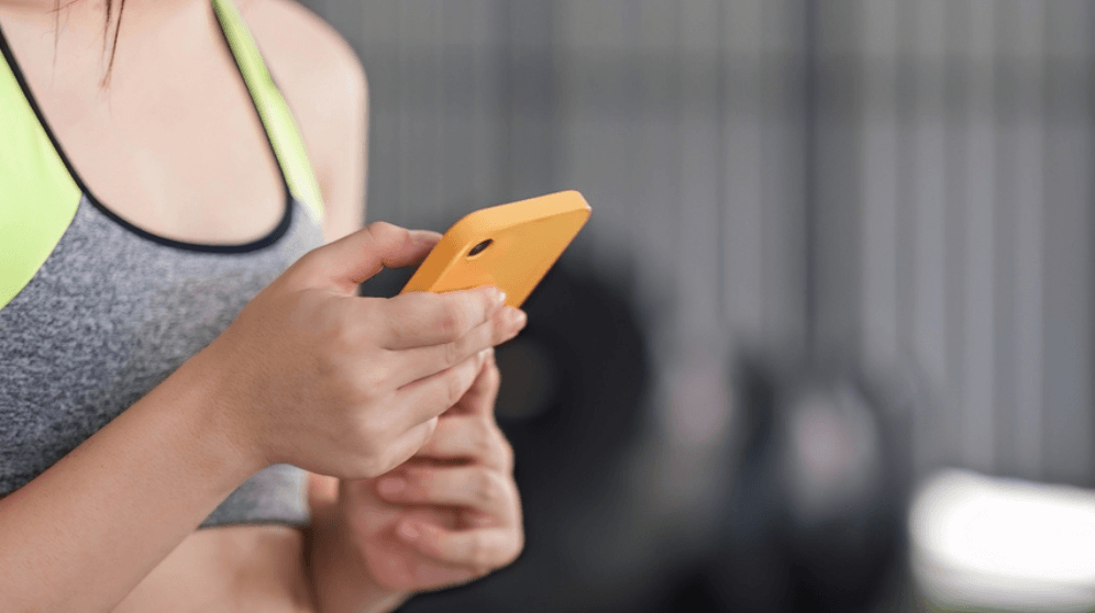 A woman excercising with a mobile phone