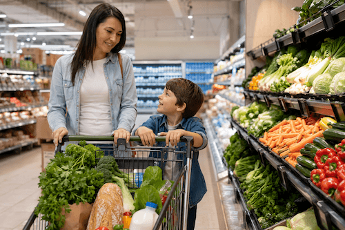 A mother and son shopping healthy grocery at a supermarket.