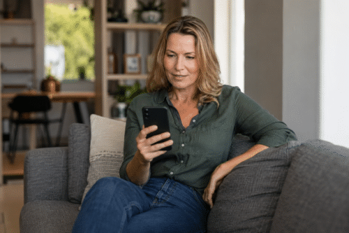 A woman reading an interesting content on health insurance app.