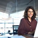 Woman in an office using a computer to manage digital customer engagement